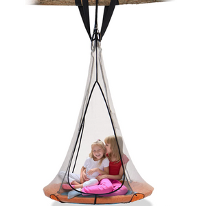 2 little girls sitting on a saucer swing hanging on tree trunk